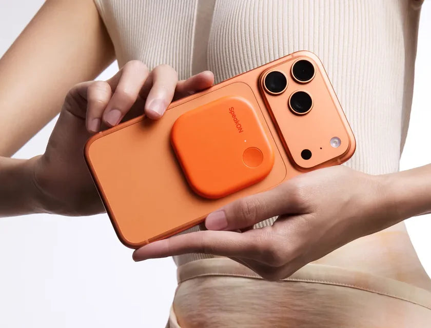 Orange SpeakON MagSafe AI Button attached to an orange iPhone
