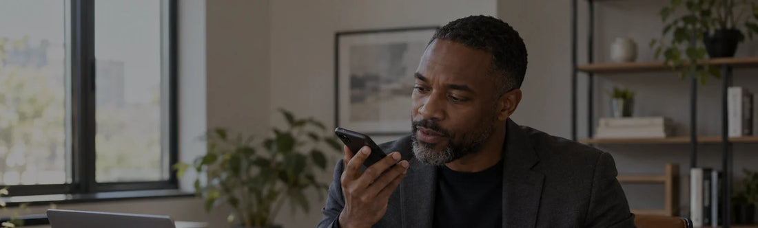 Professional using voice input on a smartphone at a desk