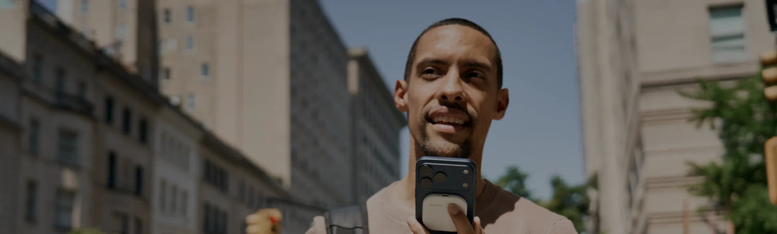 Man speaking into an iPhone with a white SpeakON device attached