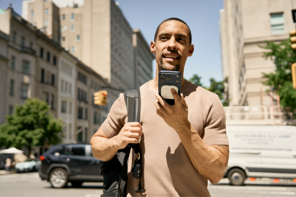A man records key details with SpeakON while walking outdoors.
