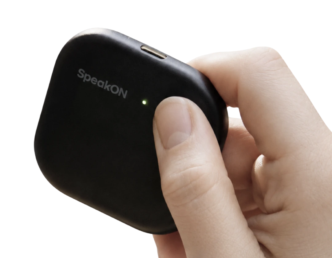 A hand pressing the button on a SpeakON device